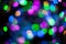 Abstract blurred background with numerous colourful bright festive bokeh. Texture with copy space for text. Celebration, holidays