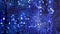 Abstract blurred glitter blinking blue background. Wall of shining holiday decoration.