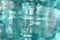 Abstract blurred greenish blue textured glass background.