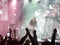 Abstract blurred image. Crowd during a entertainment public concert a musical performance. Hand fans in fun zone people