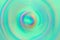 Abstract blurred multicolored whirling concentric circles background spectrum vivid pastel colors on turquoise backdrop