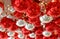 Abstract blurred photo of the ceiling filled with shiny red and silver ball shaped ornaments for background