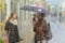 Abstract blurred silhouettes of people with umbrellas on rainy day in city, two girls seen through raindrops on window