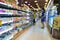 Abstract blurred supermarket aisle with colorful shelves and unrecognizable customers as background