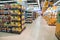 Abstract blurred supermarket aisle with colorful shelves and unrecognizable customers as background