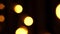 Abstract bokeh background in motion. shining, blurred golden particles, lights. bright bokeh from garlands on dark