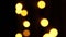 Abstract bokeh background in motion. shining, blurred golden particles, lights. bright bokeh from garlands on dark