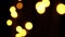 Abstract bokeh background in motion. shining, blurred golden particles, lights. bright bokeh from garlands on dark