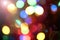 Abstract bokeh background, slightly blurry colored lights, festive city street