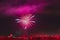 Abstract bright blurred background of fireworks, silhouettes of unrecognizable people back to us, celebrate holiday