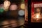 Abstract candle lantern light on wood table in blur bokeh pub re