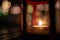 Abstract candle lantern light on wood table in blur bokeh pub re