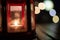 Abstract candle lantern light on wood table in blur bokeh pub re