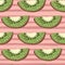 Abstract cartoon seamless pattern with simple green kiwi elements. Pink striped background
