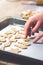 Abstract Christmas food background with cookies molds and flour. Baking Christmas cookies - table, cookie cutters and cookies.