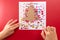 abstract Christmas tree, DIY fingerprint craft, kids hands doing greeting card on red background