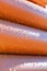Abstract close up of a stack of orange plastic pipes on construction