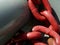 Abstract closeup of heavy welded steel red chain links in harbor