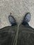 Abstract closeup view of a half of the person body from up down standing on grey asphalt surface, ground