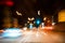 Abstract colorful background, car at speed, light traffic lights, pointers and signs, nightlife in metropolis