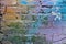 Abstract colorful blue, purple,orange, white and green painted brick wall