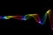 Abstract colorful raibow wavy smoke flame over black background