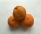 Abstract composition of unpeeled tangerines. Minimalistic background.