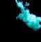 Abstract concept of teal color ink drop plume in water on an isolated  black background
