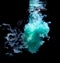 Abstract concept of teal color ink drop plume in water on an isolated  black background