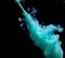 Abstract concept of teal color ink drop plume in water on an isolated  black background