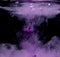 Abstract concept of violet color ink drop plume in water on an isolated  black background