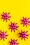 Abstract Corona virus Covid-19 strain model on yellow background top-down pattern copy space