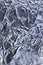 Abstract crumpled textured silver aluminum foil, large detailed vertical background closeup texture pattern in blue