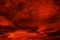 Abstract dark red background. Dramatic red sky. Red sunset with clouds. Fantastic sunset background with copy space for design.