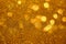 Abstract defocused circular golden luxury gold glitter bokeh lights background