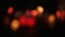 Abstract defocused colorful blinking lights. Christmas and New Year garland on a black background. Loopable.