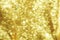 Abstract defocused shiny sparkle gold glitter bokeh background