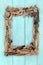 Abstract Driftwood Frame on Rustic Blue Wood