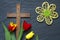 Abstract easter tulips and wooden cross on black marble