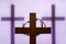 Abstract easter wooden cross and crown of thorns on purple background