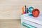 Abstract education, red apples, multicolored pens and white books with wooden backgrounds