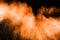 Abstract explosion of orange dust. abstract orange powder splatter on black background