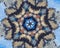 Abstract extruded mandala with blue, brown, white, orange