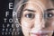 Abstract eyesight image with attractive happy european female portrait, digital eye lens and letters on dark background. Optical