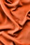 Abstract fabric texture. Trend shade of orange-red color. Top view