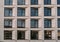 Abstract facade of new modern building wall with windows, house exterior