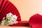 Abstract fashion podium for advertising cosmetics products. Red podium paper oriental fan pink pastel background