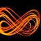 Abstract fiery pattern in the shape of the number 8. Drawing shapes with fire at night  infinity sign  bright colors on night