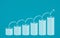 Abstract financial chart with stack of dollar coins and arrow in chalk Scribble design on blue color background