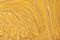 Abstract fluid art background dark golden and yellow colors. Liquid marble. Acrylic painting with ocher gradient